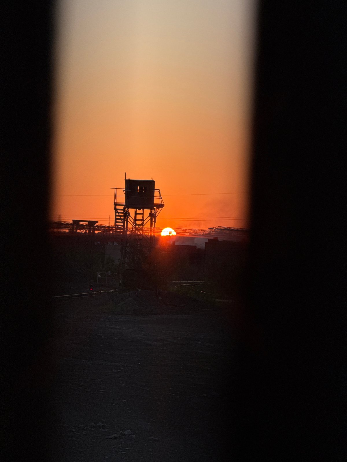 Guard tower cuts a stark silhouette against Magnitogorsk sunset
