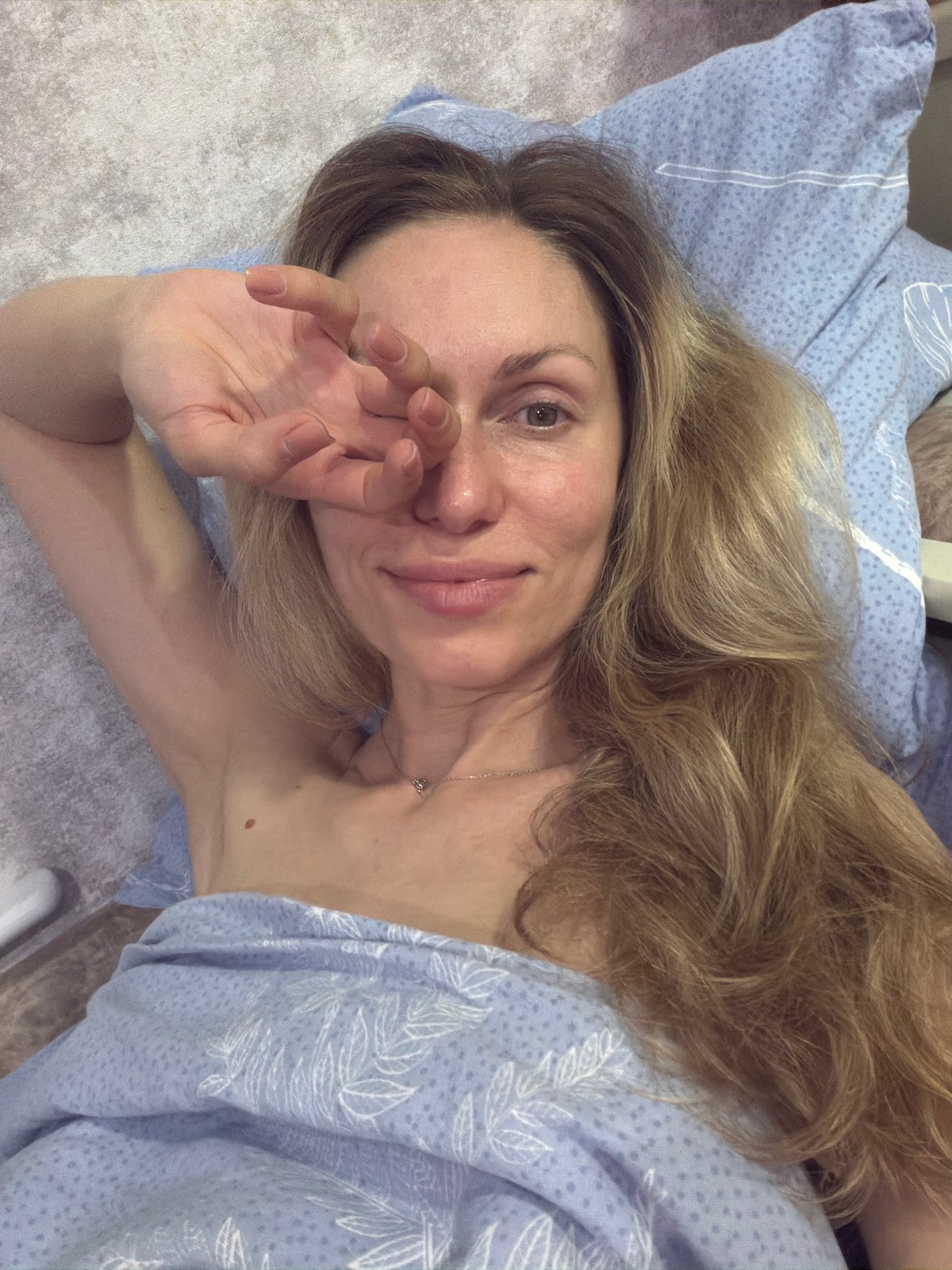 Resting on a blue pillow, hand over eye, indoors in Sochi
