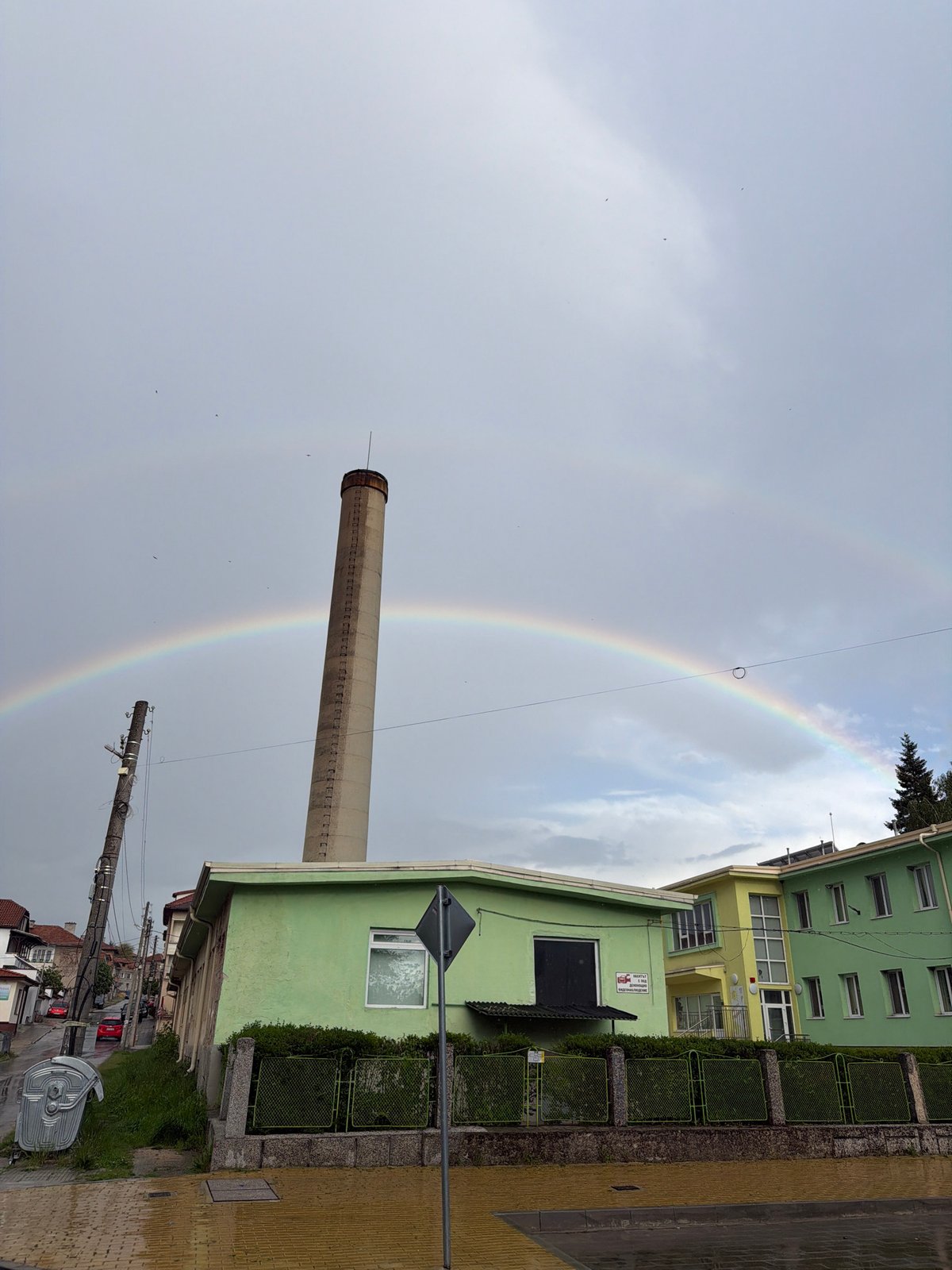 Rainbow appears over industrial smokestack in Panagyurishte, Bulgaria