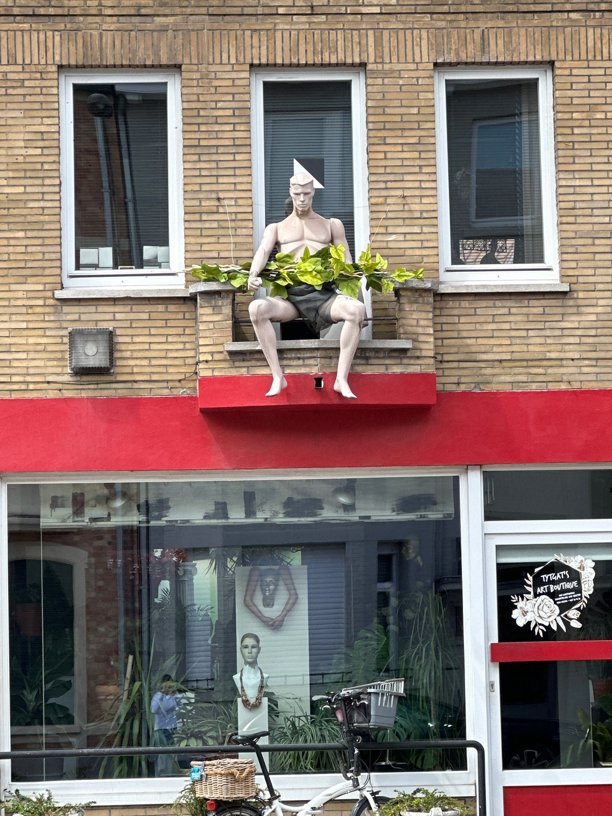 Street-level details from a Bruges neighborhood: architecture, murals, sculpture
