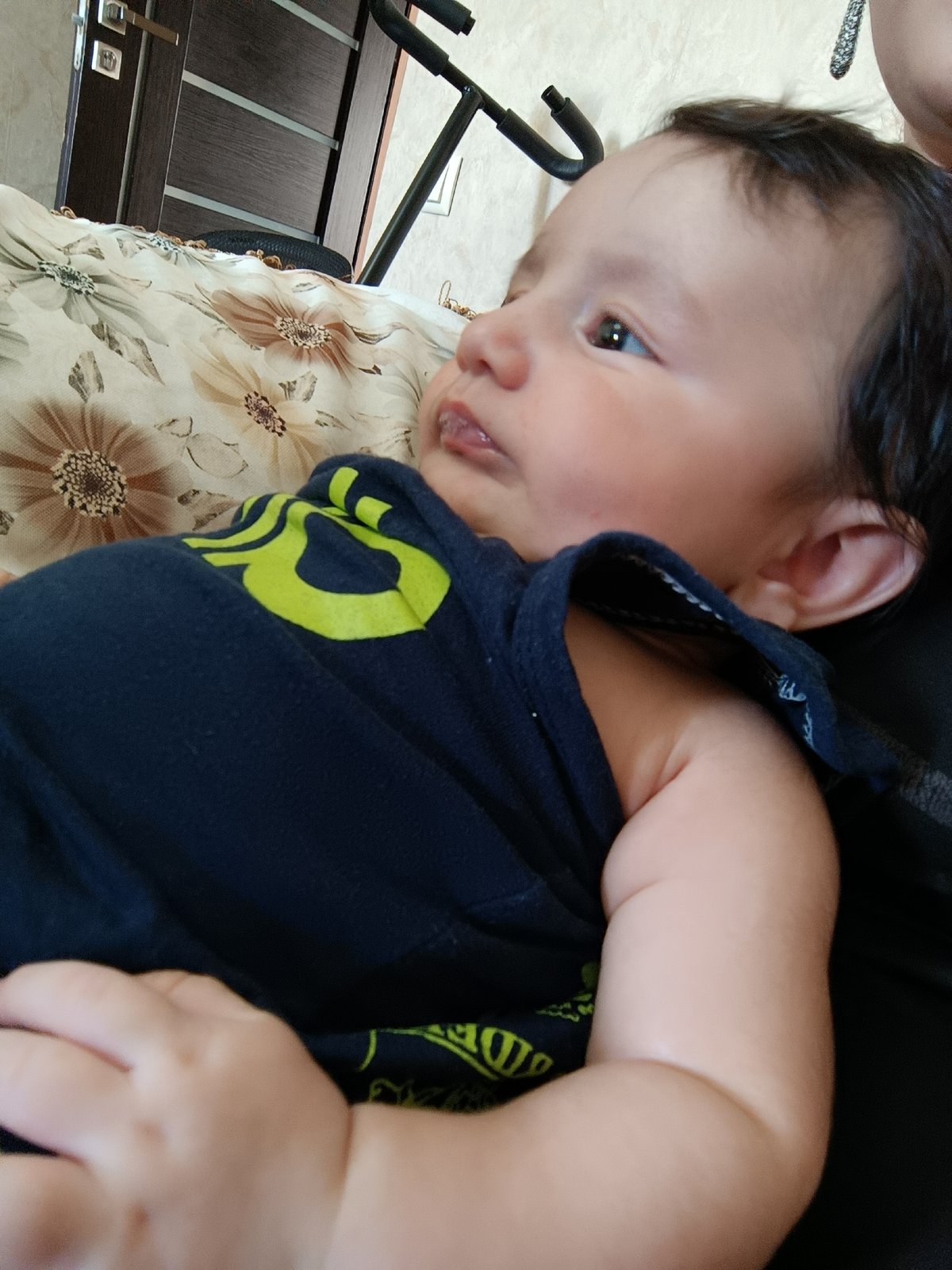 Baby in dark blue shirt gazes upward, Yerevan