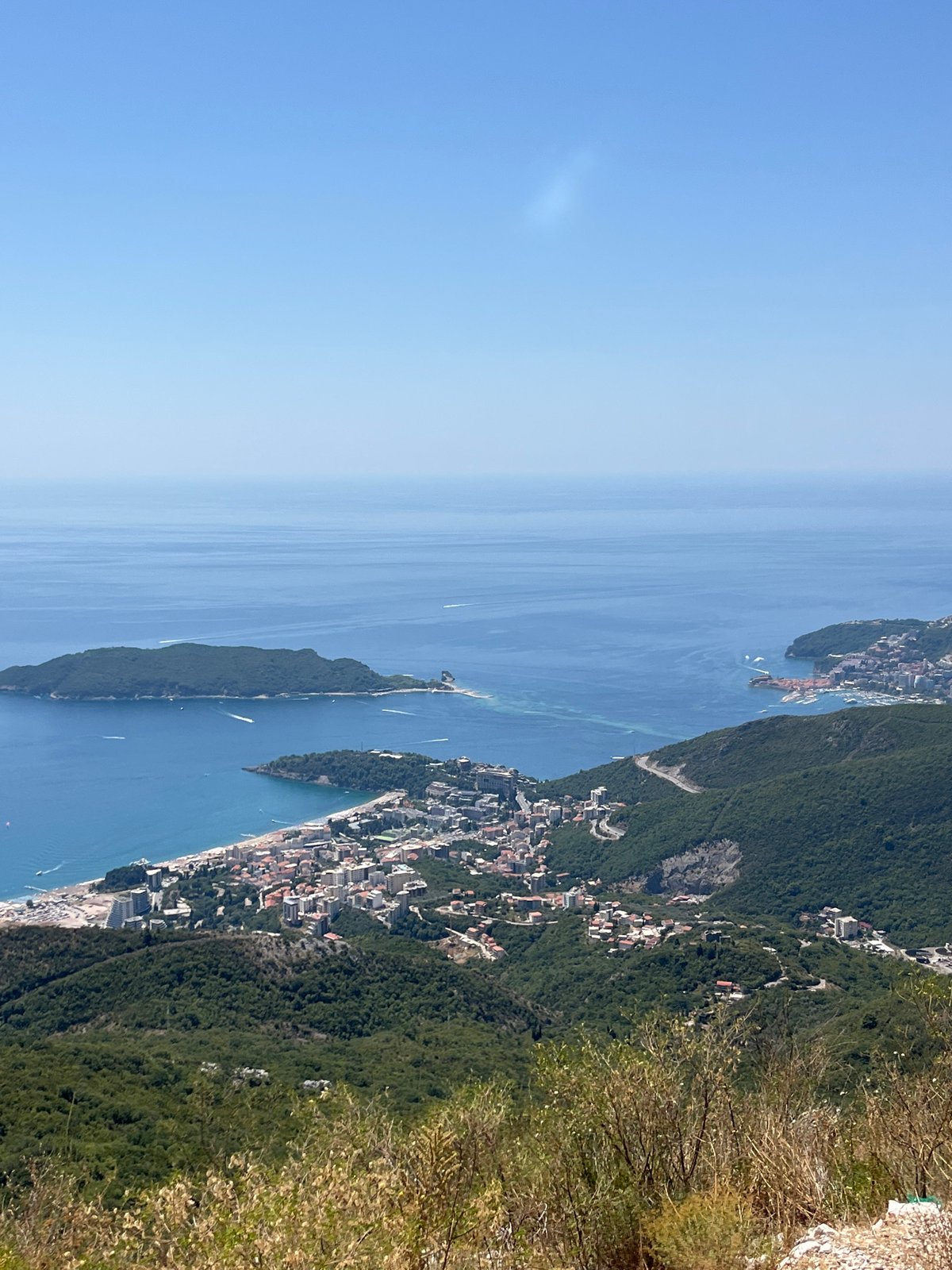 Paragliding over Brajici's Adriatic coastline on a clear morning
