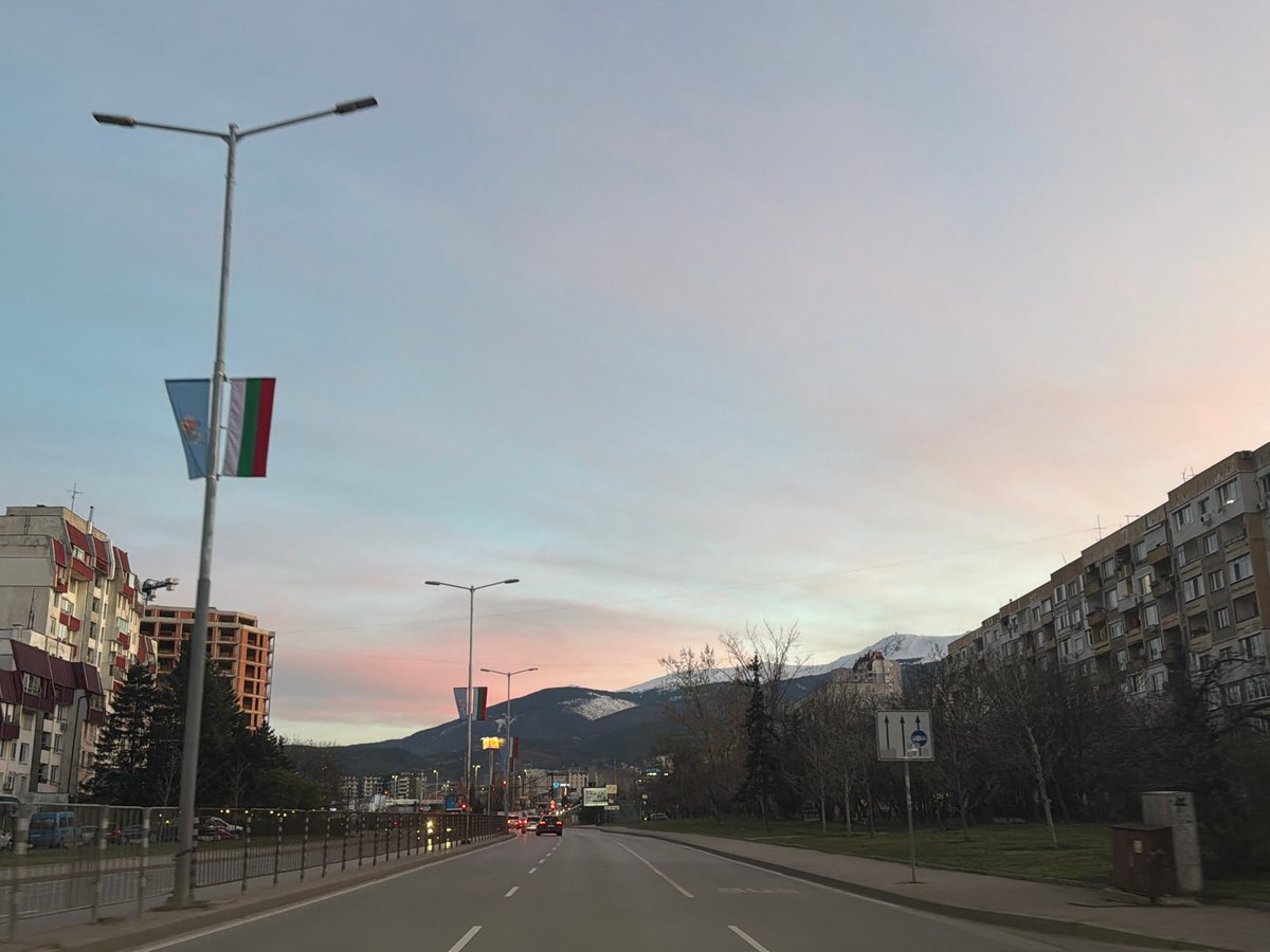 Evening traffic scene captured on Sofia street at dusk