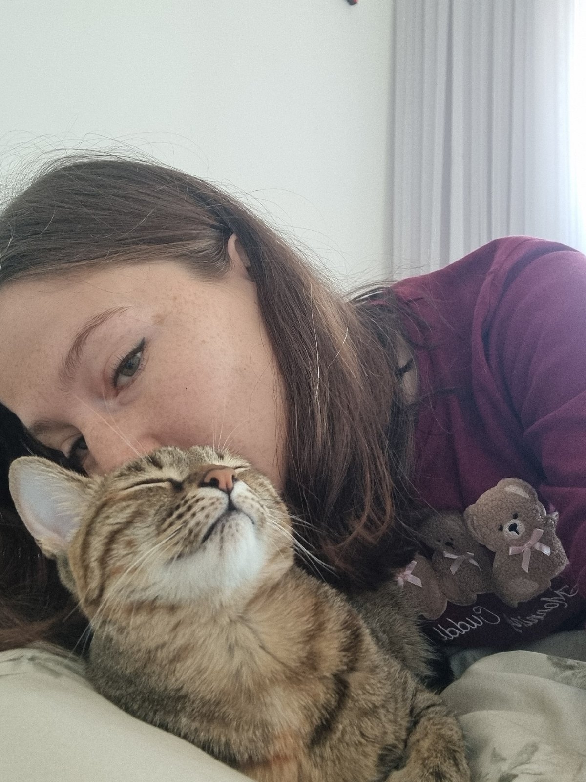 Person shares quiet morning moment with tabby cat in Ramat Gan