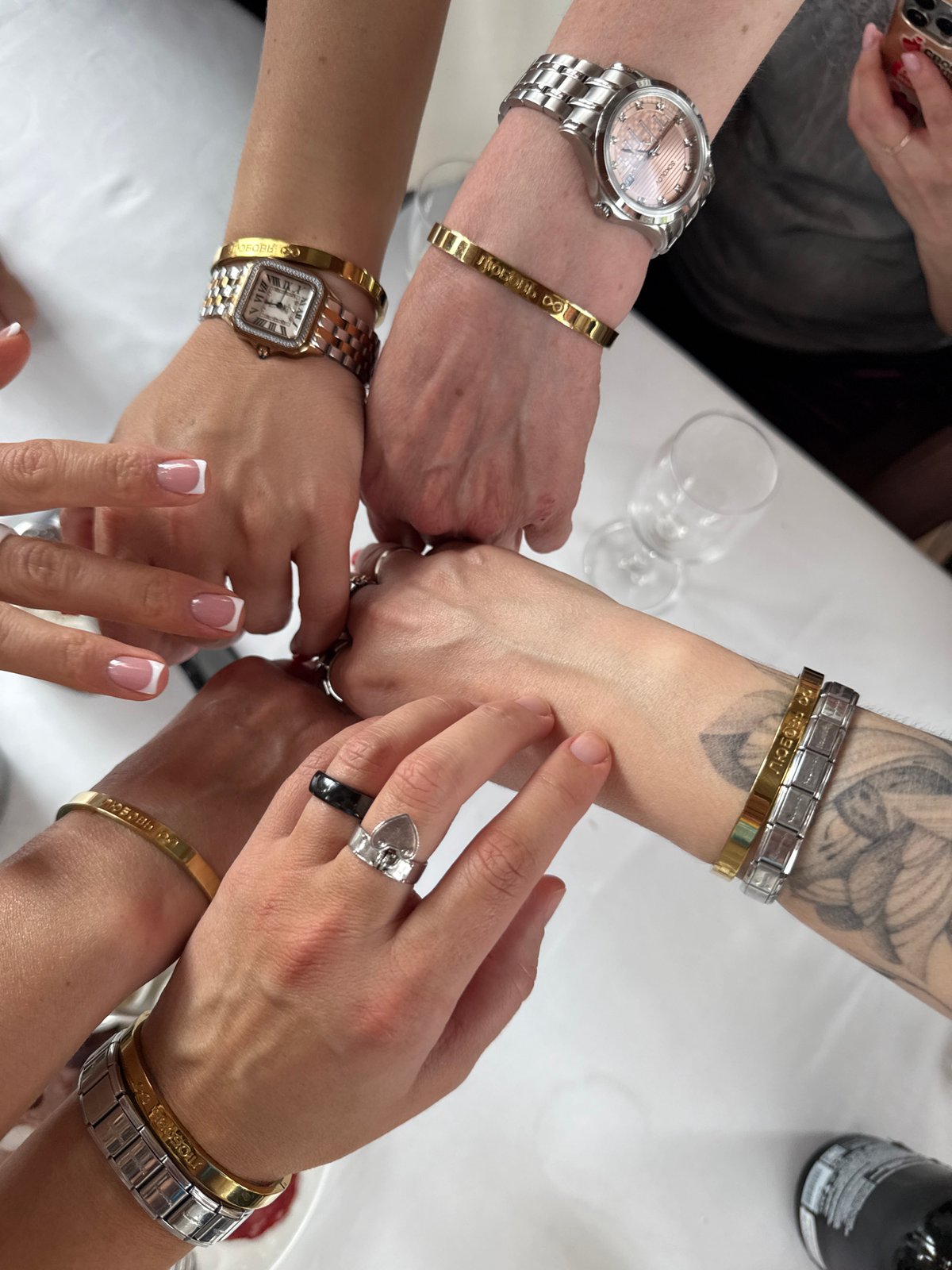 Women gather around Moscow table in celebratory gesture
