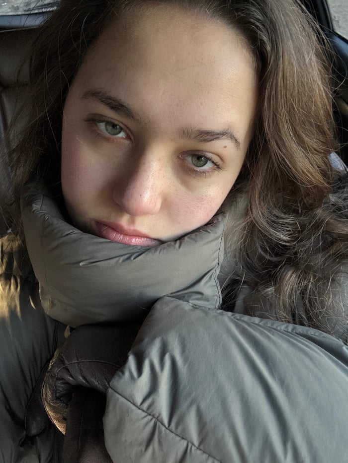 Woman photographed in car with smartphone, Sofia morning