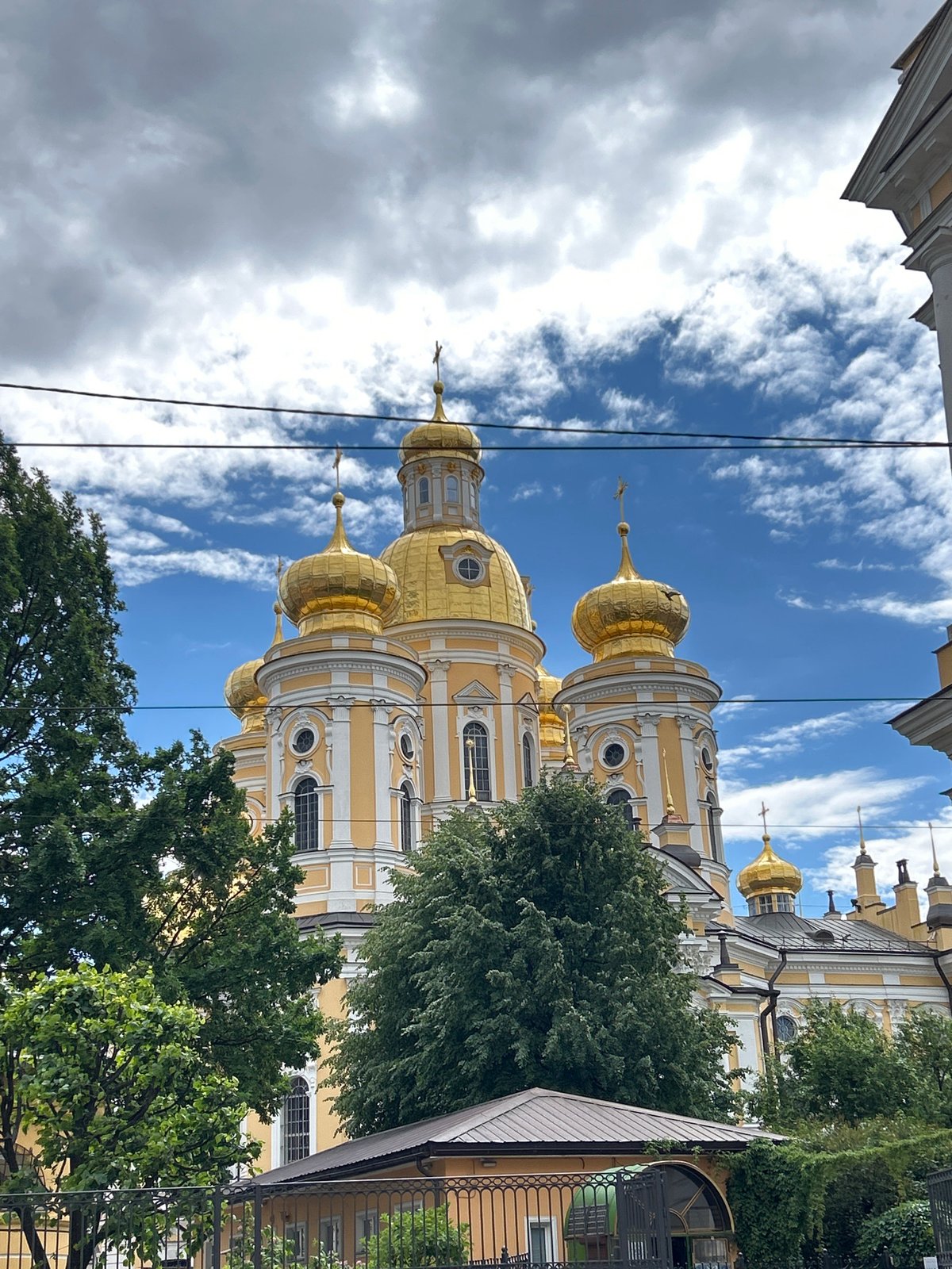 Golden domes and canal boats along a Russian riverfront