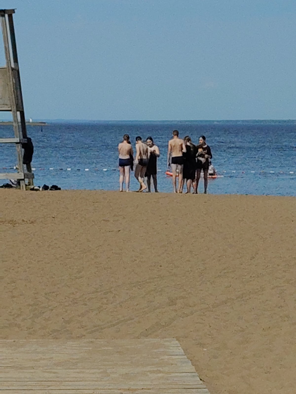 Beach day activities and graduation celebration documented near lake