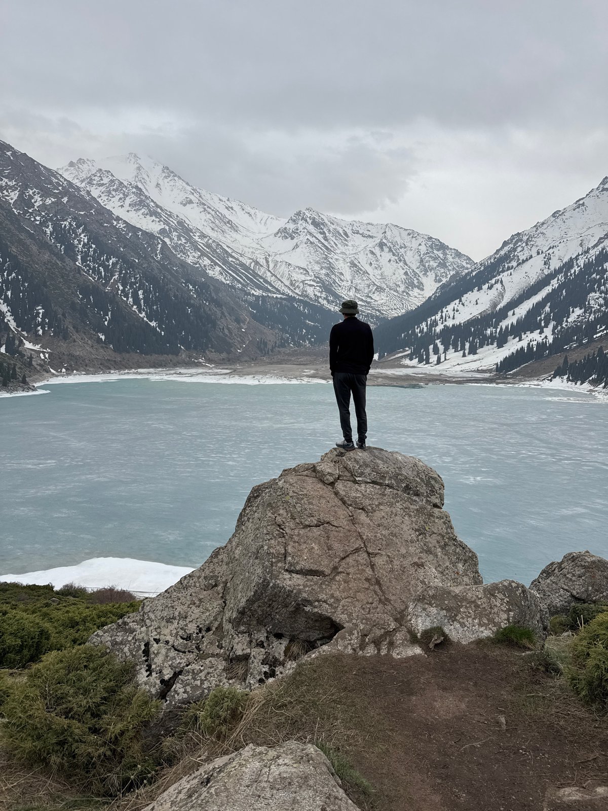 Tourist documents scenic mountain lake visit near Almaty, Kazakhstan