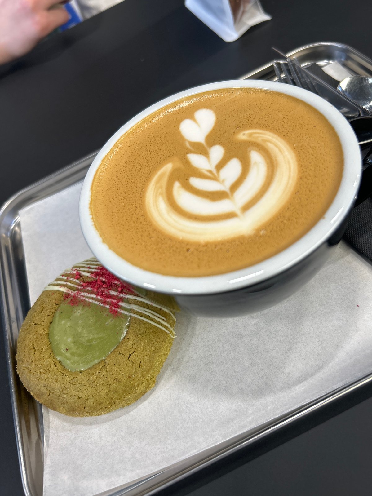 Coffee and decorated cookie served at Izhevsk cafe