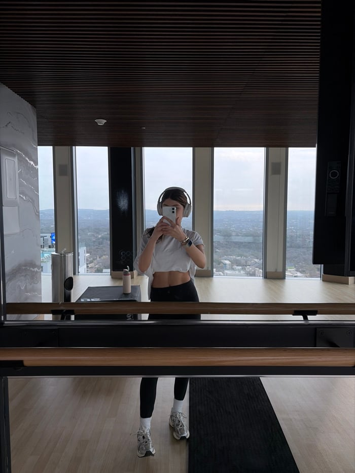 Woman photographs Austin skyline from high-rise apartment Friday evening