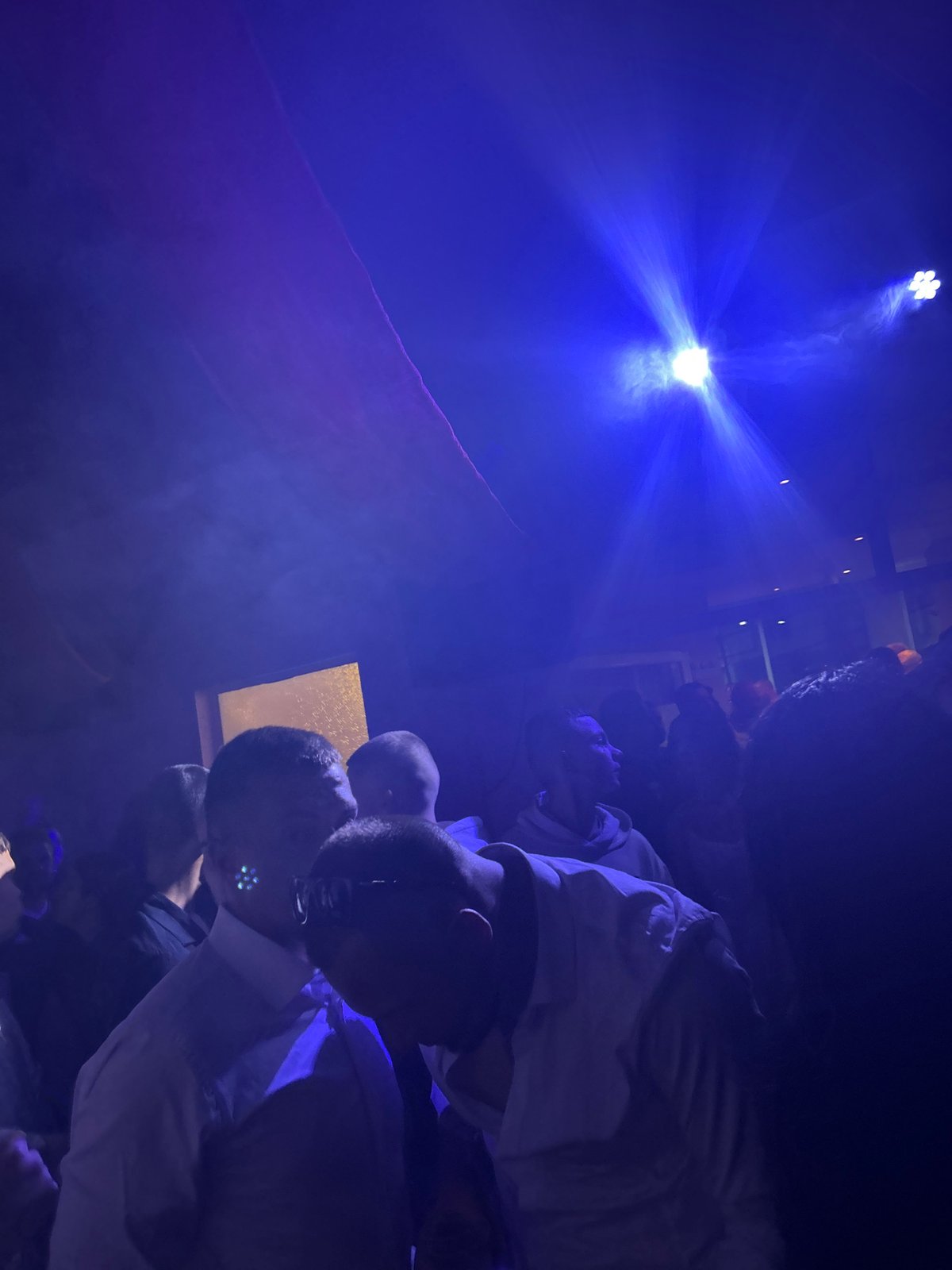 Group illuminated by bright blue light indoors in Bulgaria