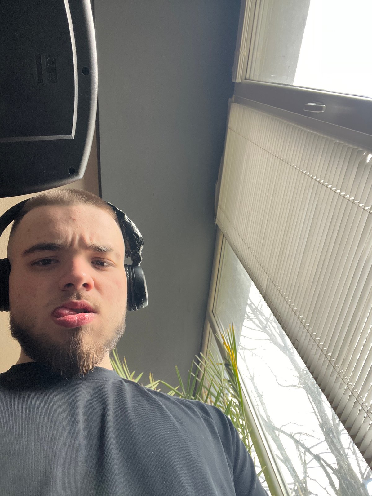 Man photographed making playful expression while wearing headphones in Bulgaria