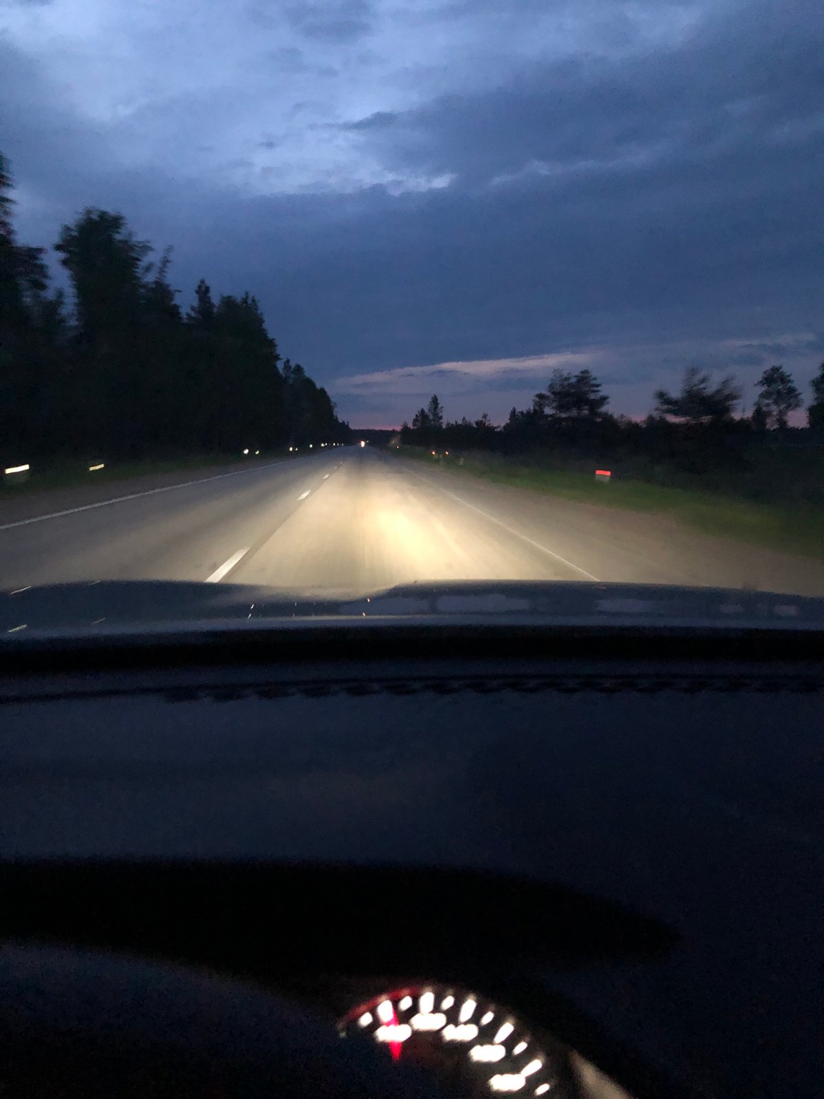 Vehicle travels highway near Kingisepp during twilight hours