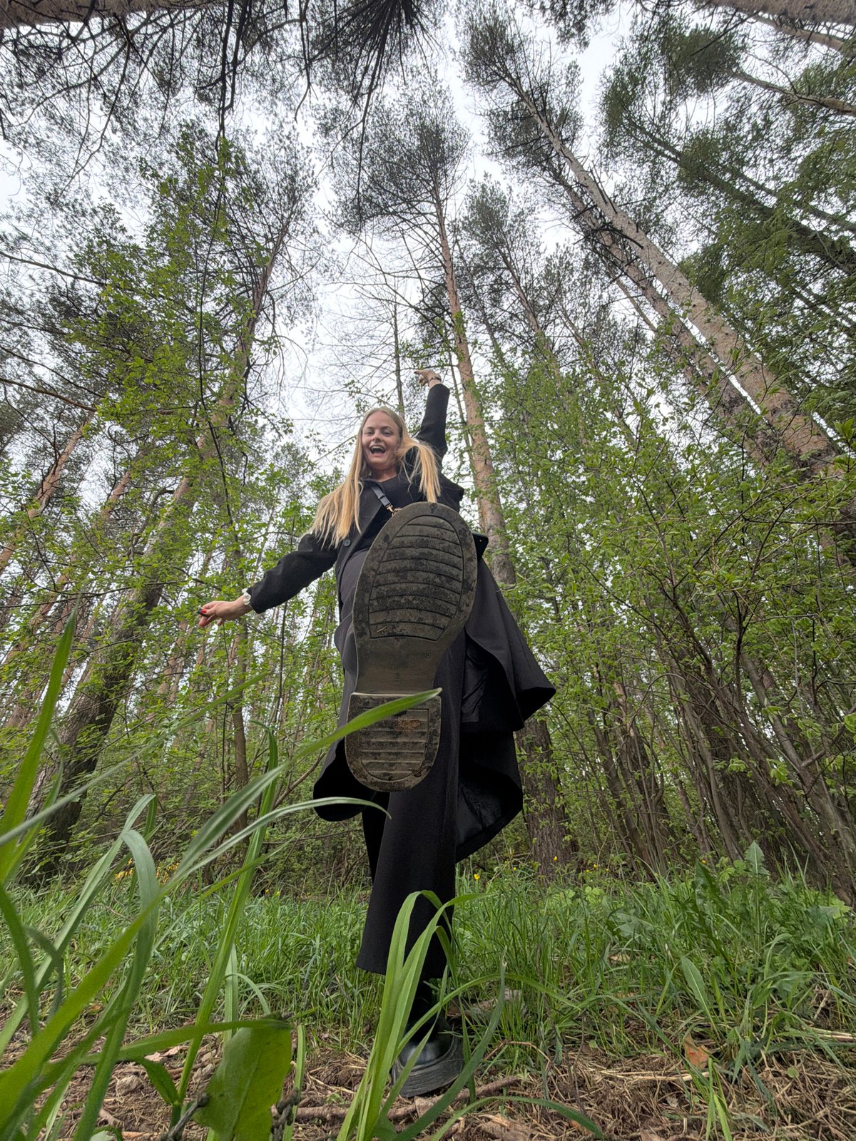 Woman photographs herself in Izhevsk forest during morning outing