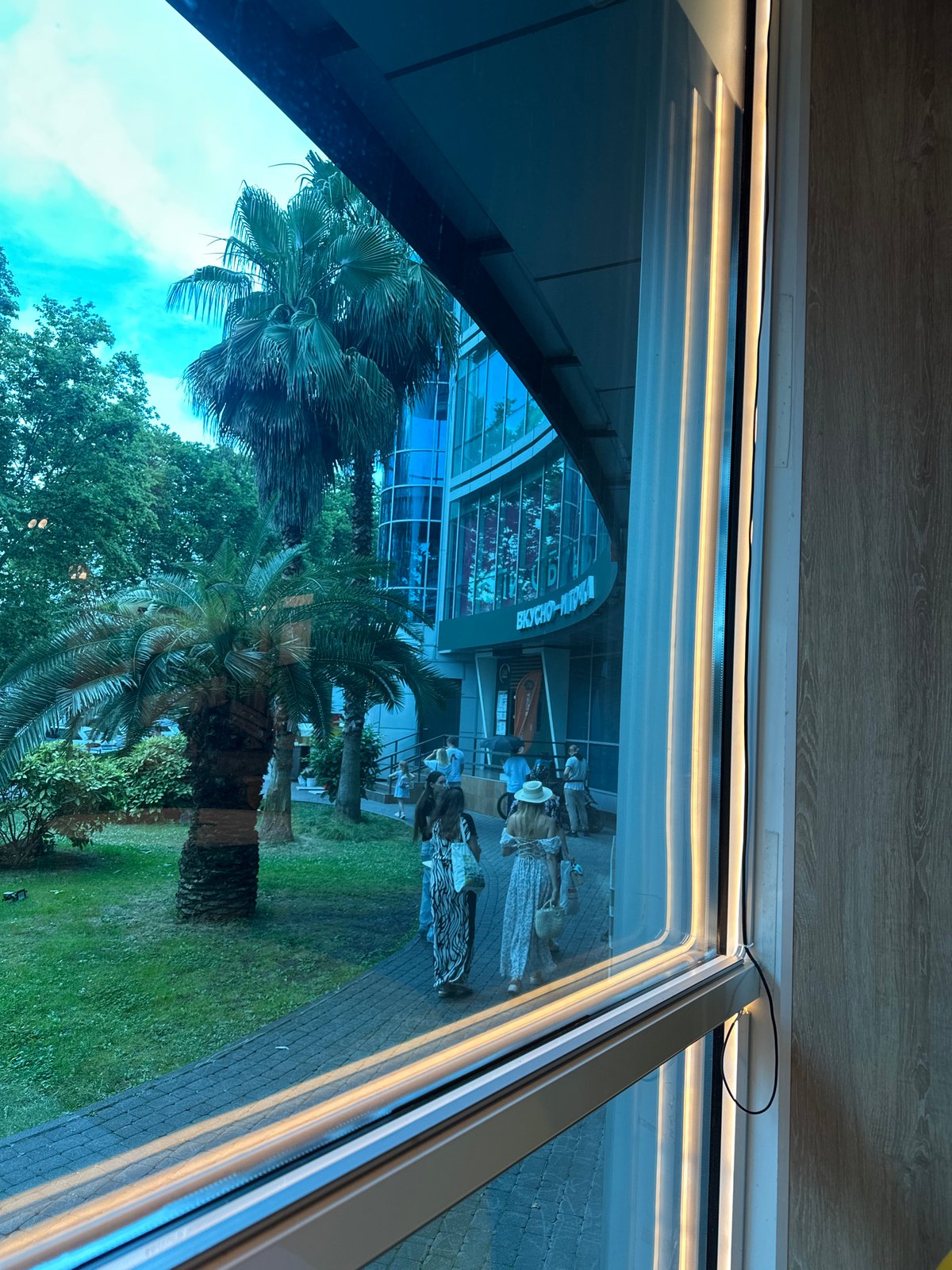Lunch break at a Sochi McDonald's near a glass-facade landmark