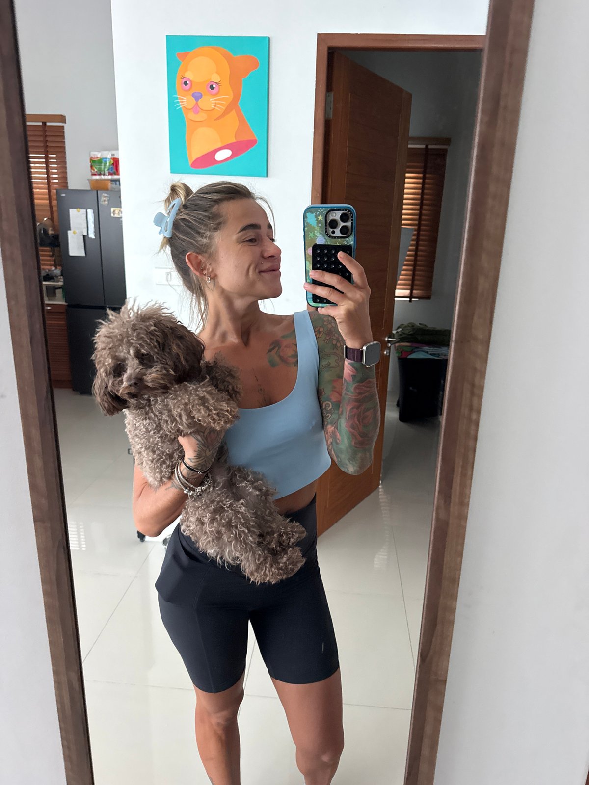 Back-to-back selfies in a Thep Krasatti room, dog in tow