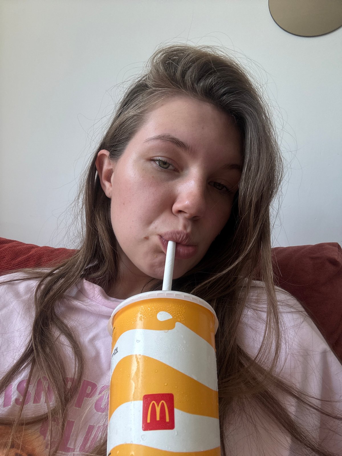 Woman drinks McDonald's beverage while resting in Belgrade suburb