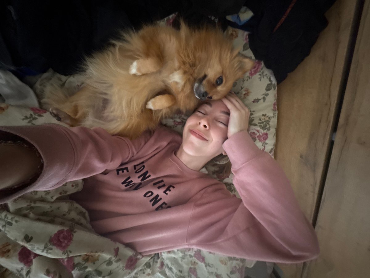 Person and Pomeranian share quiet morning moment in Sofia
