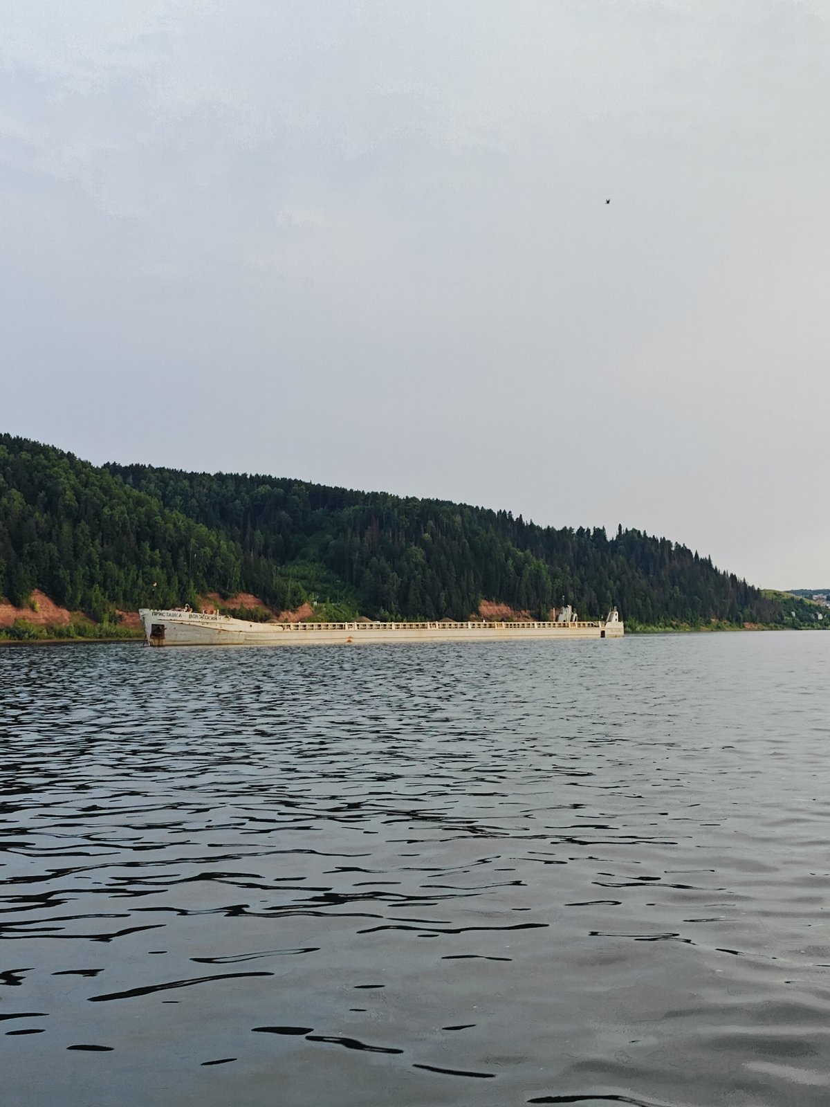 White barge and infrastructure along the Kama River, Russia