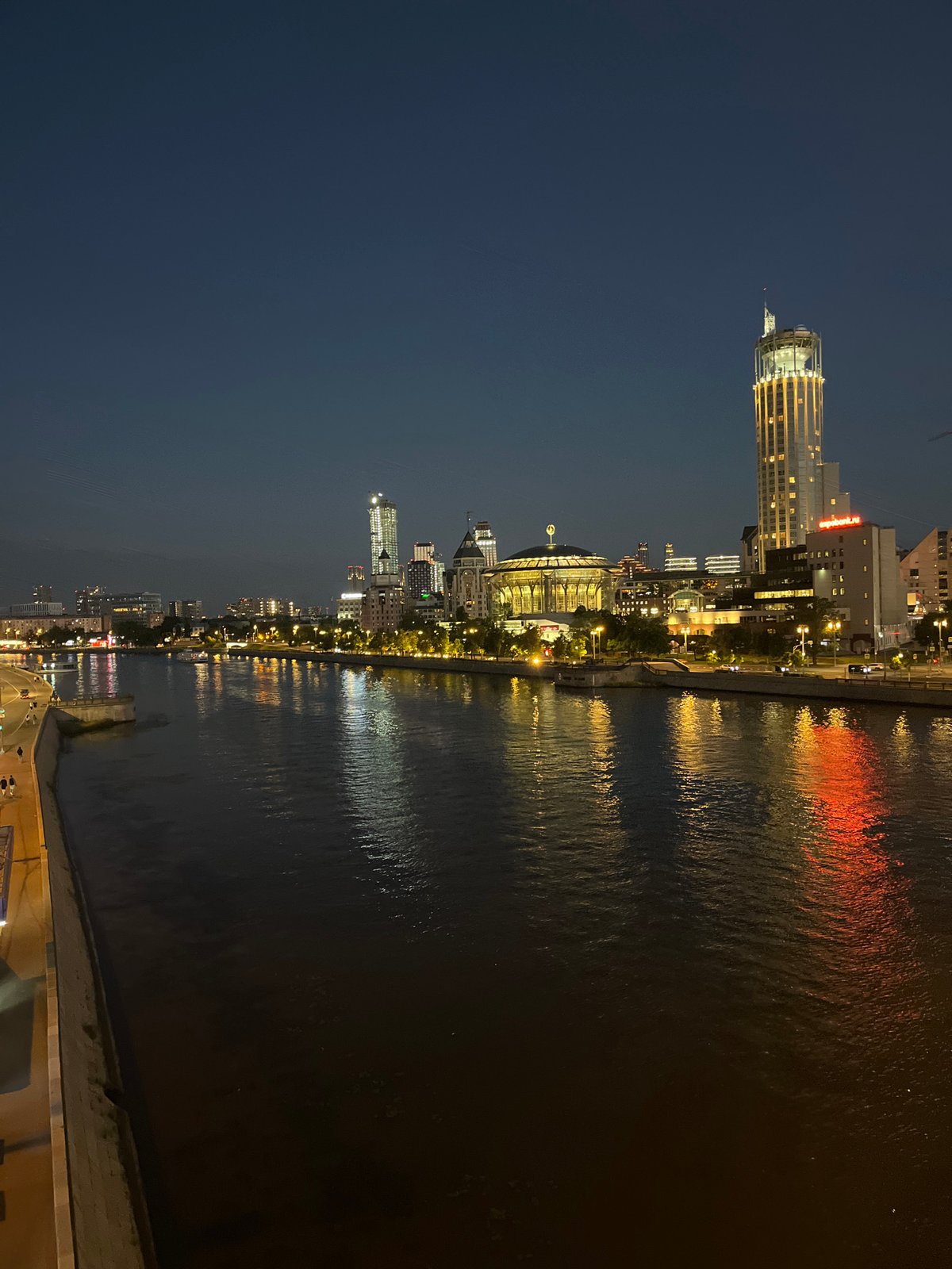 Moscow River skyline lit up at night, bridge and towers glowing