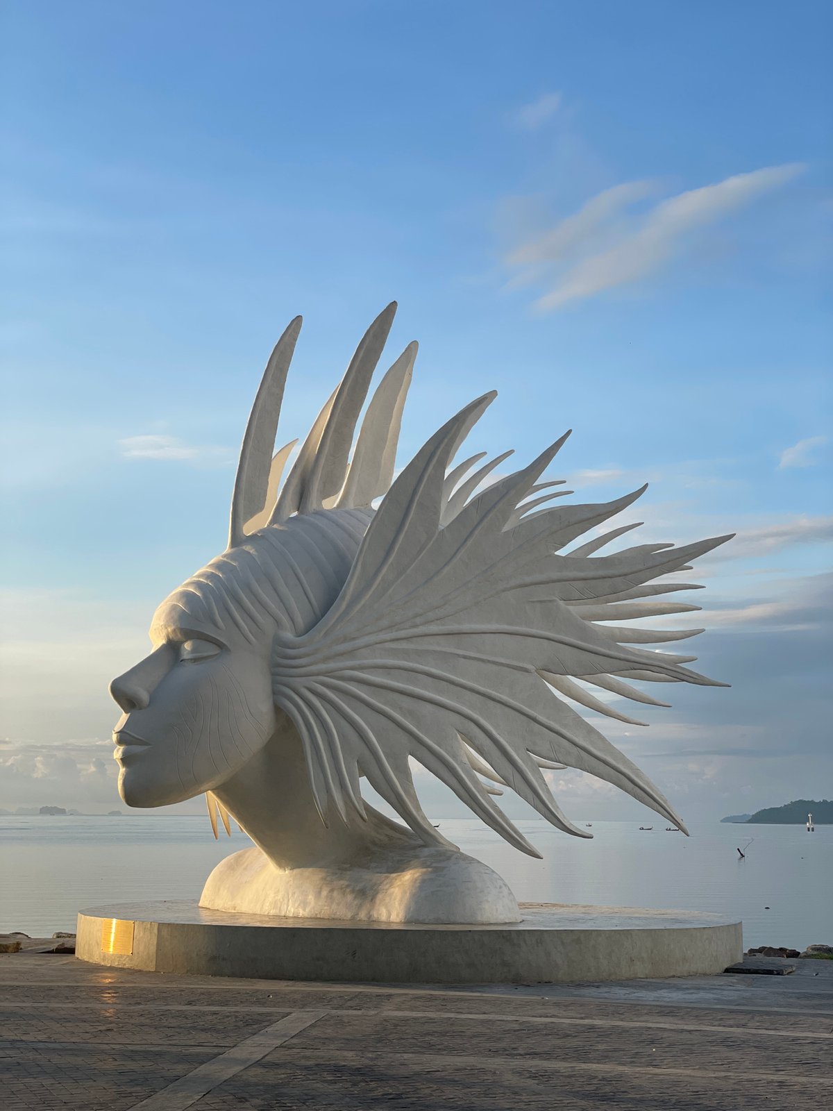 White abstract head sculpture on Phuket's seaside promenade