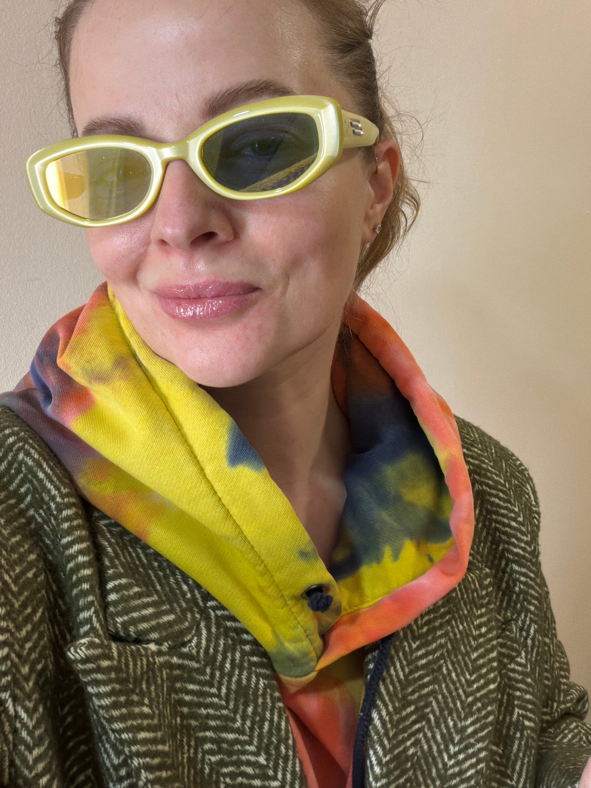 Woman takes selfies in colorful outfit in Moscow dressing room