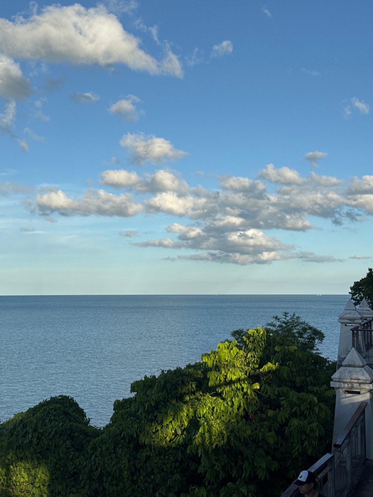 Morning stroll along a tropical clifftop walkway with ocean views