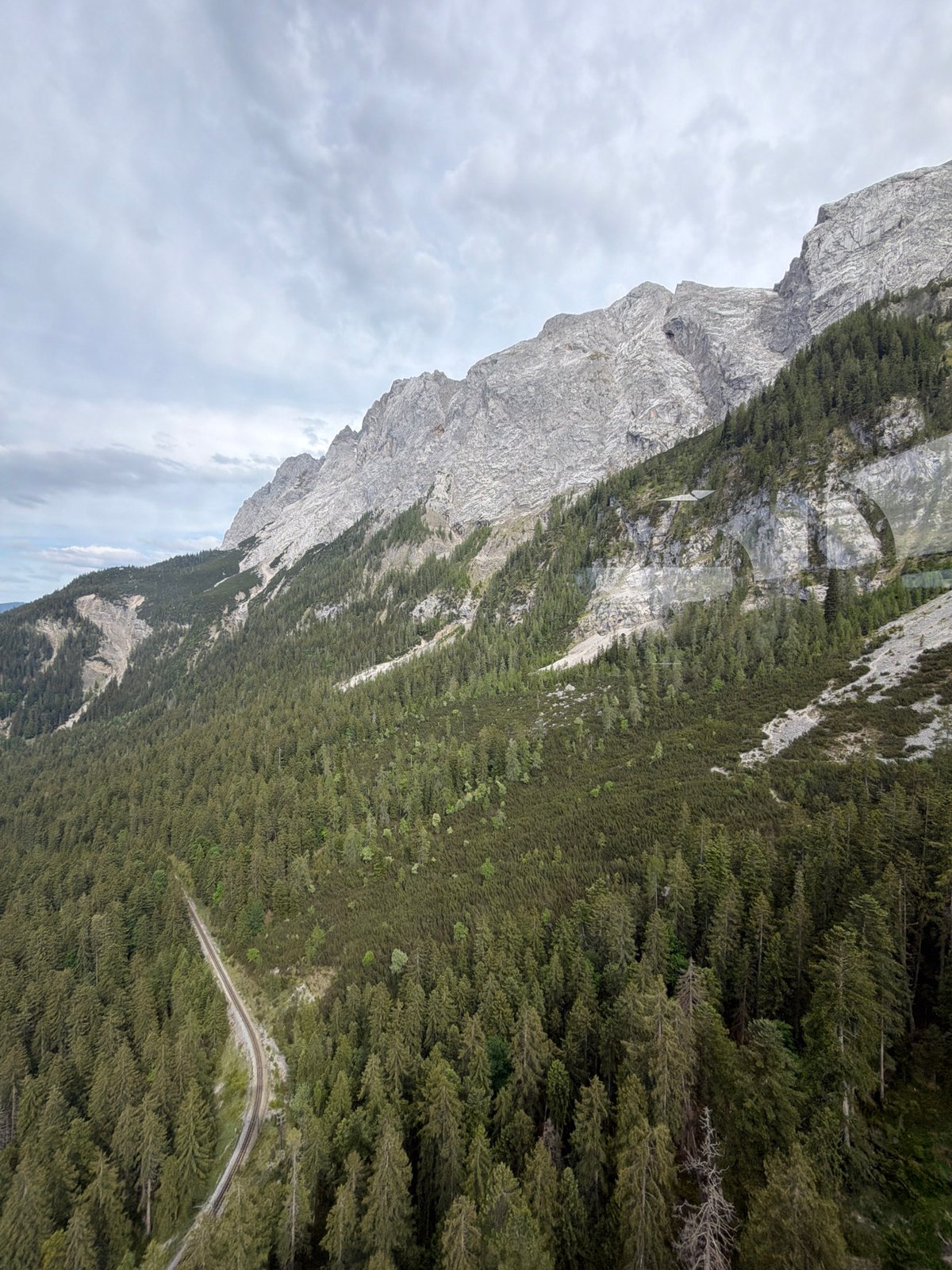 Zugspitze peaks observed through cloudy skies from Grainau