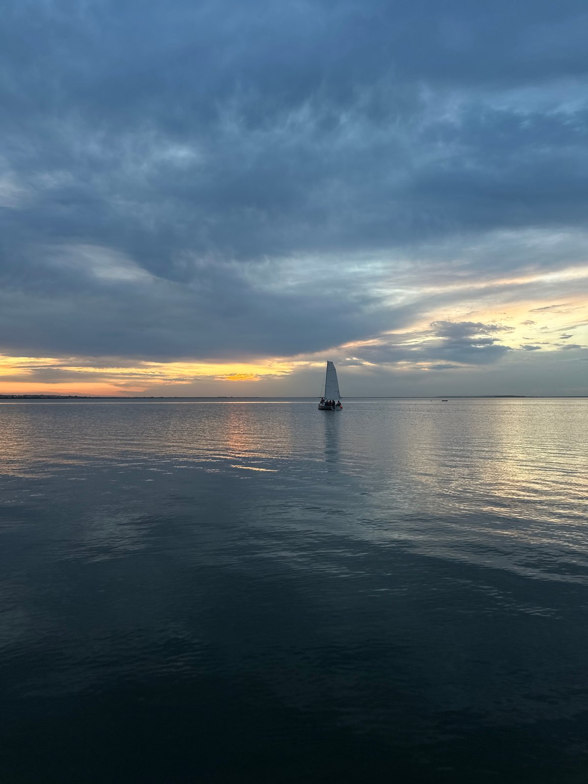 Evening boaters captured on Lake Kopa during Kazakhstan sunset