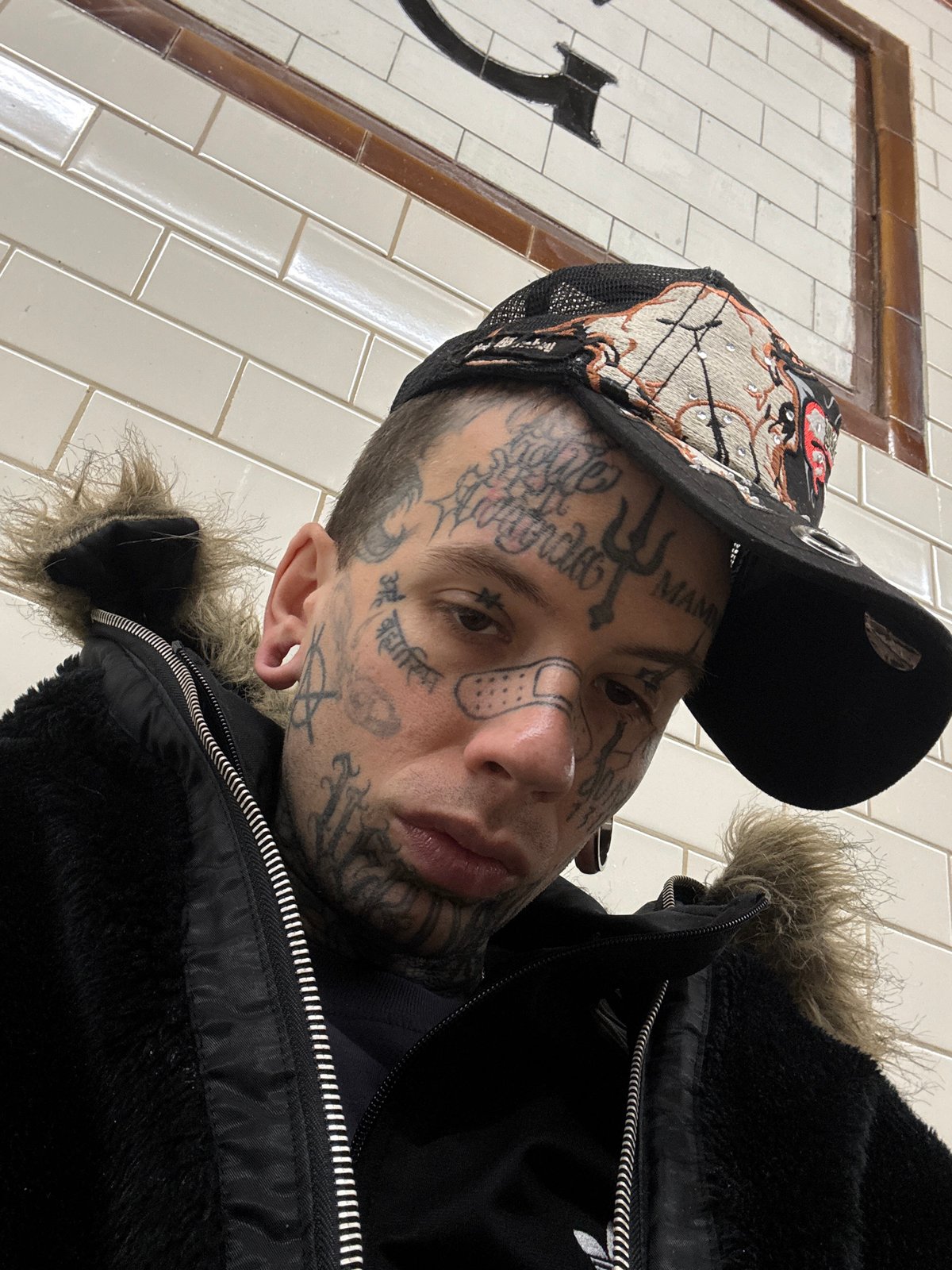 Close-up selfie with facial tattoos and fur-lined jacket, Buenos Aires