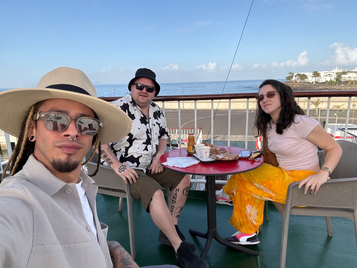 Three people relax on vessel deck near Yaiza, Canary Islands