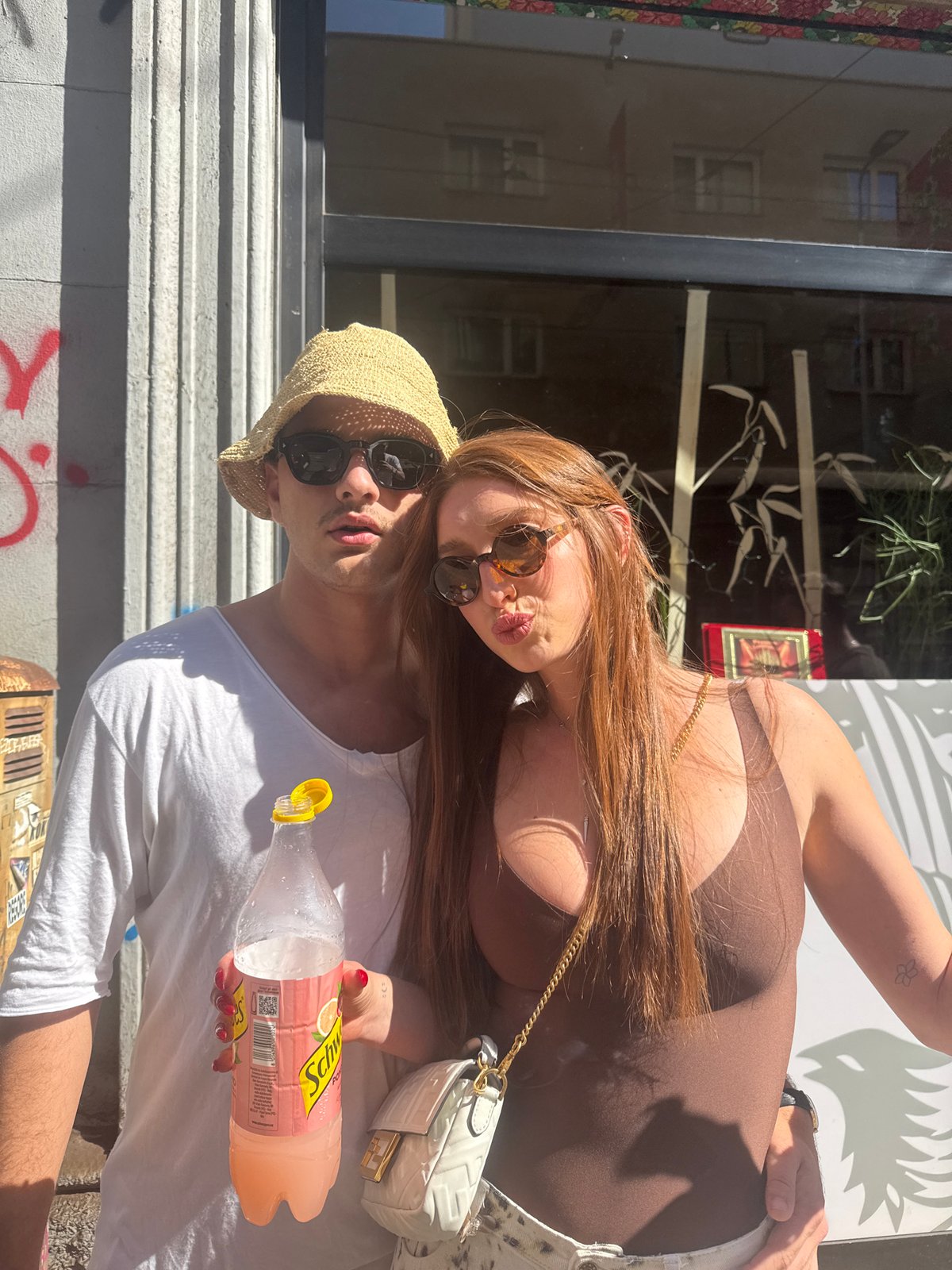 Two people pose for photo on Milan street
