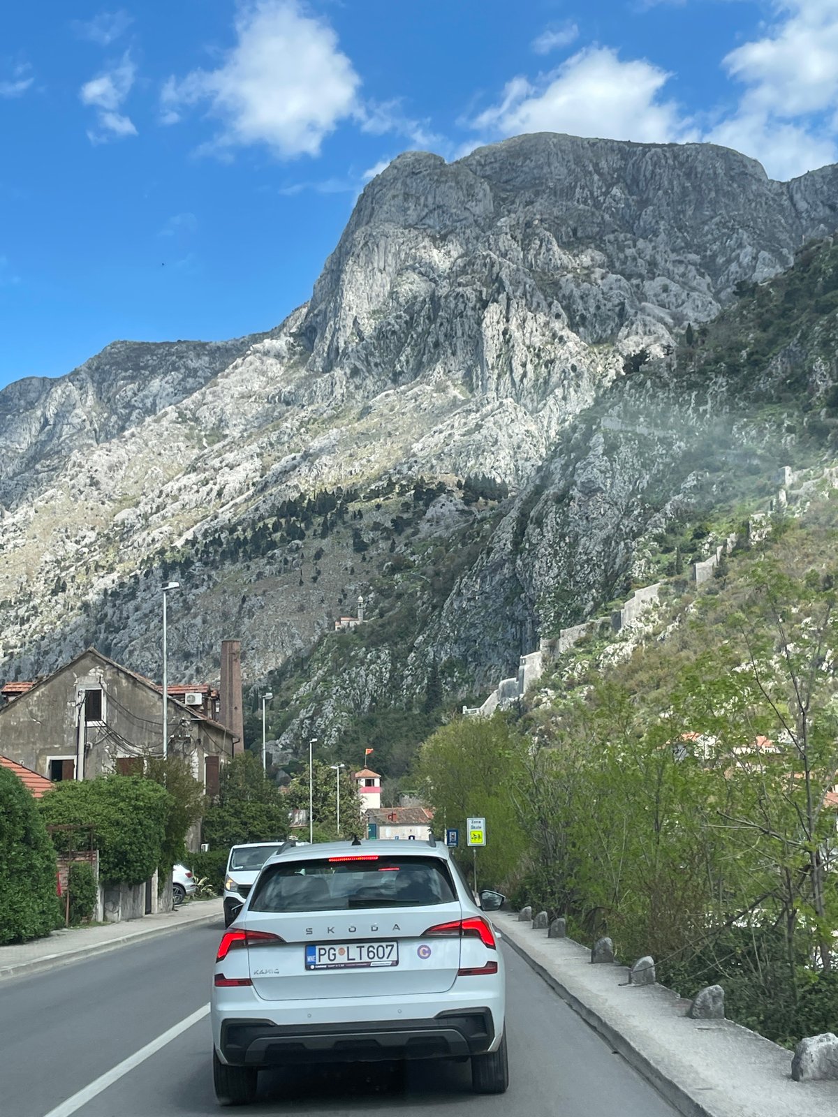 White Skoda spotted in Škaljari against mountain backdrop