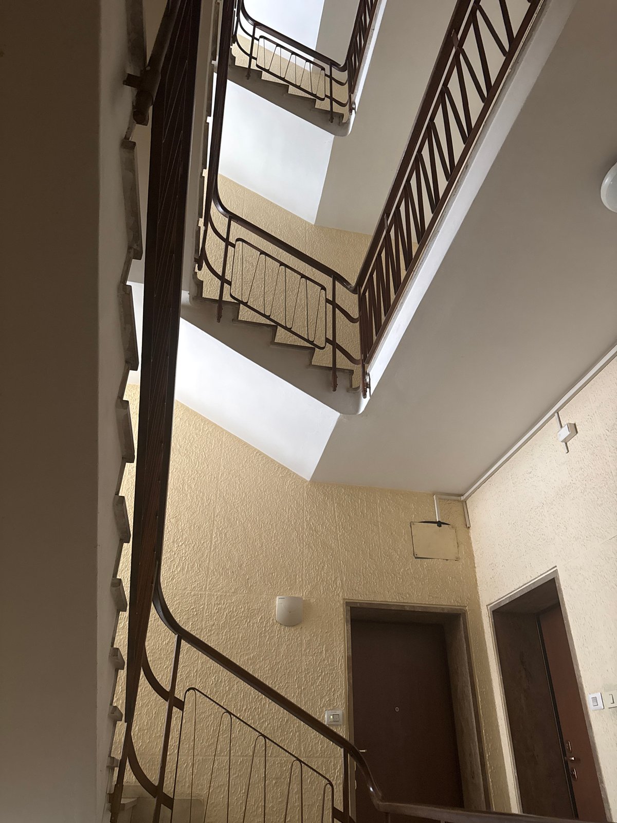 Interior stairwell with metal railings in Como apartment building
