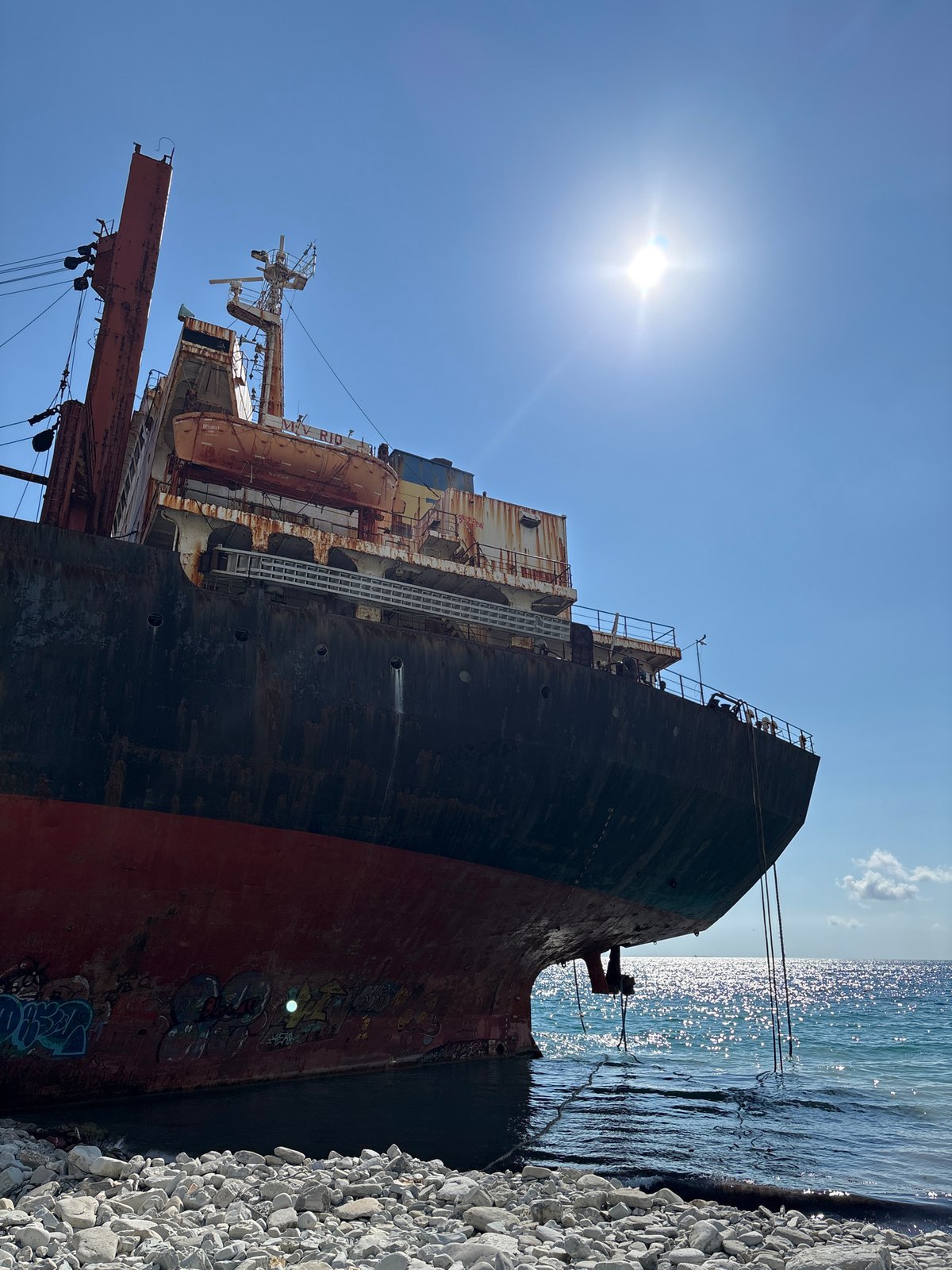 Graffiti-covered shipwreck MV Rio rusts on Kabardinka's rocky shore
