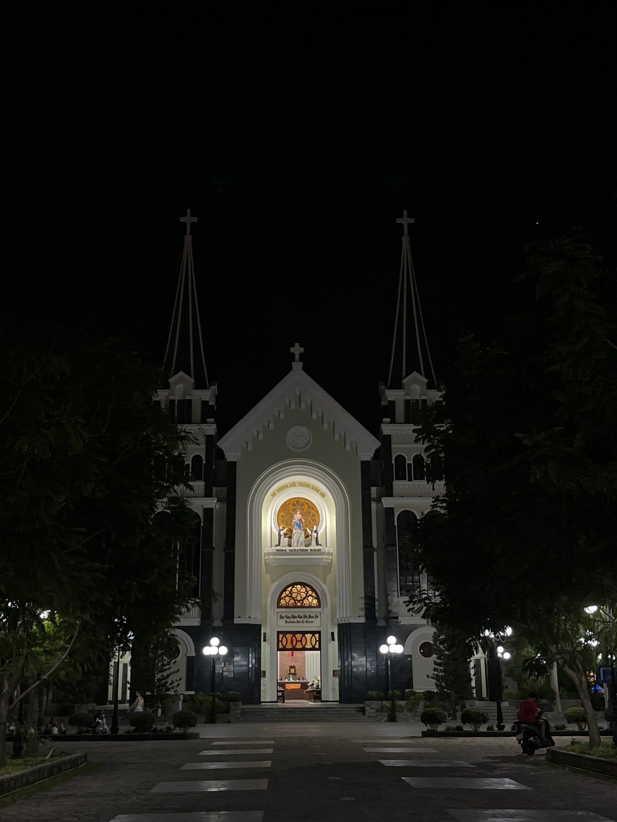 Nha Trang at night: cathedral spires, lit trees, and street life