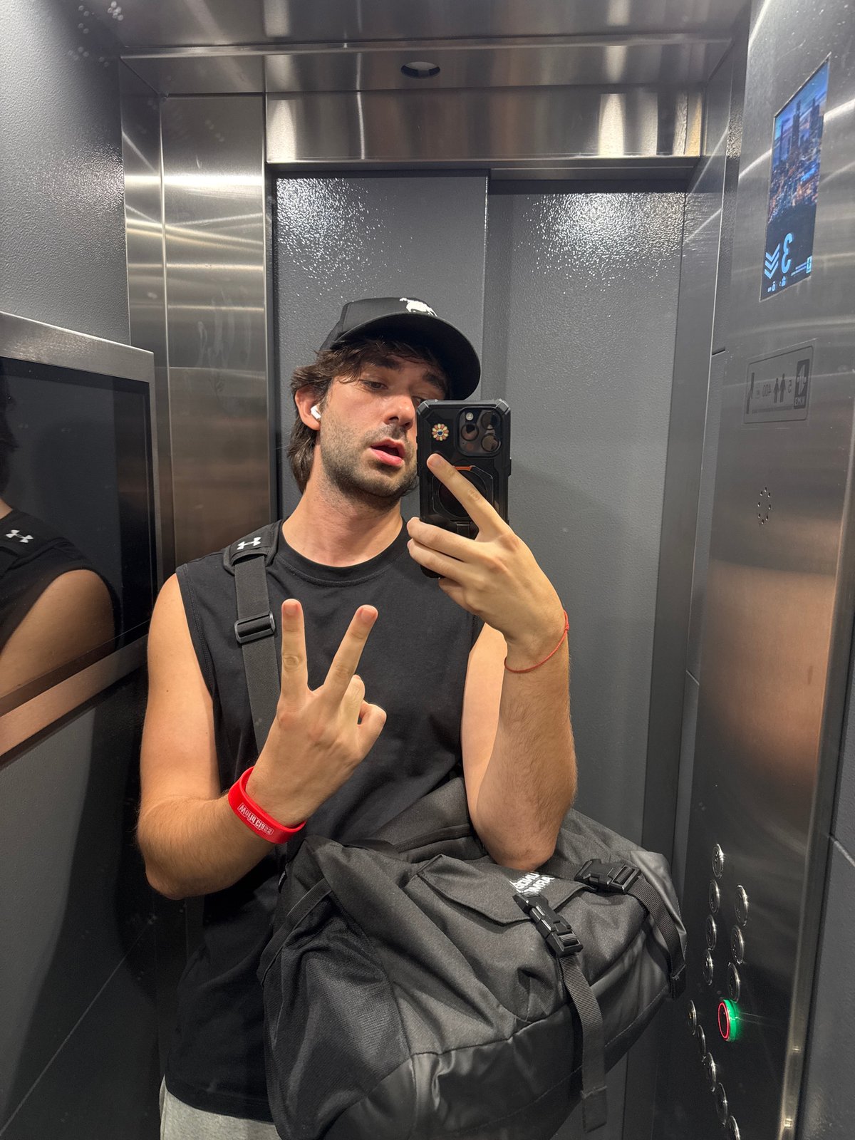 Elevator selfie moment in Moscow, casual and candid.