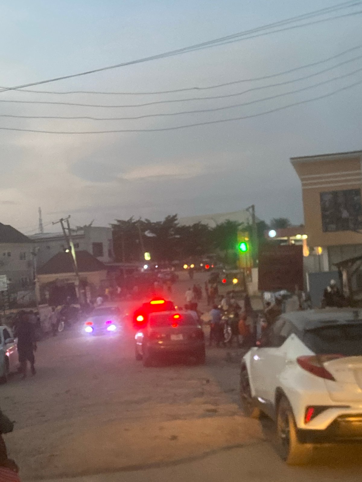Evening traffic flows through Abuja streets at dusk