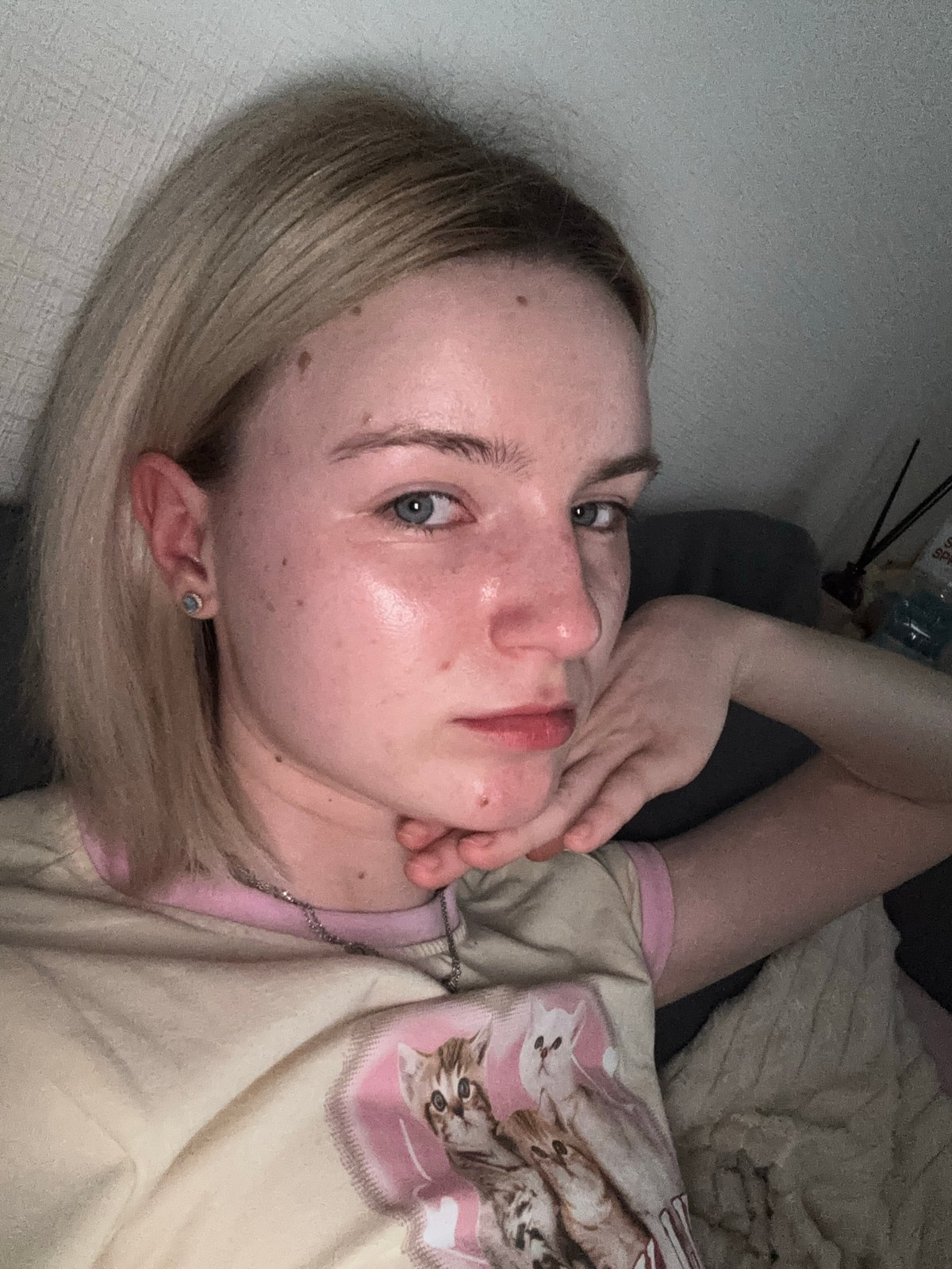 Person resting indoors wearing 'LOVELY LIFE' shirt captured close-up