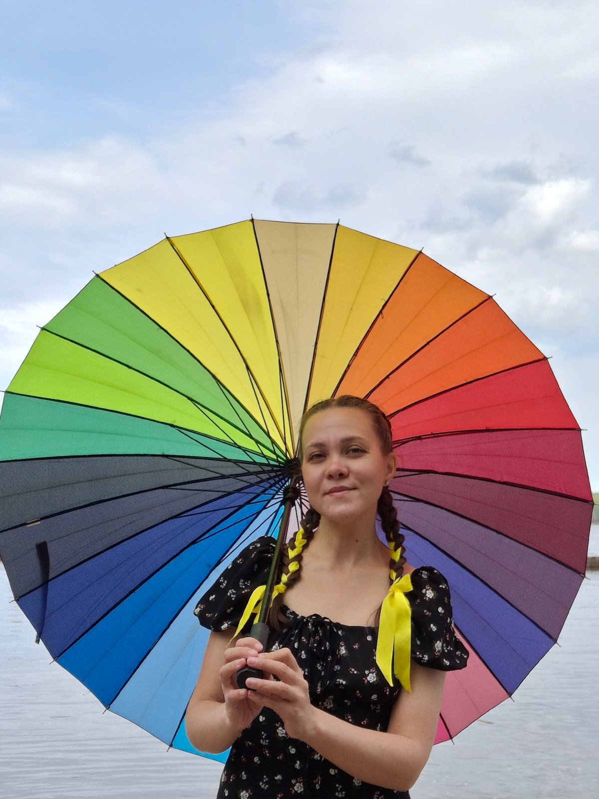 Young Woman Poses with Rainbow Umbrella During Morning Photo Session
