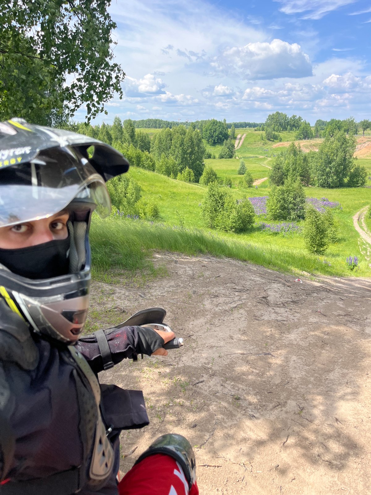 ATV rider explores birch forests and lupine fields in Russia