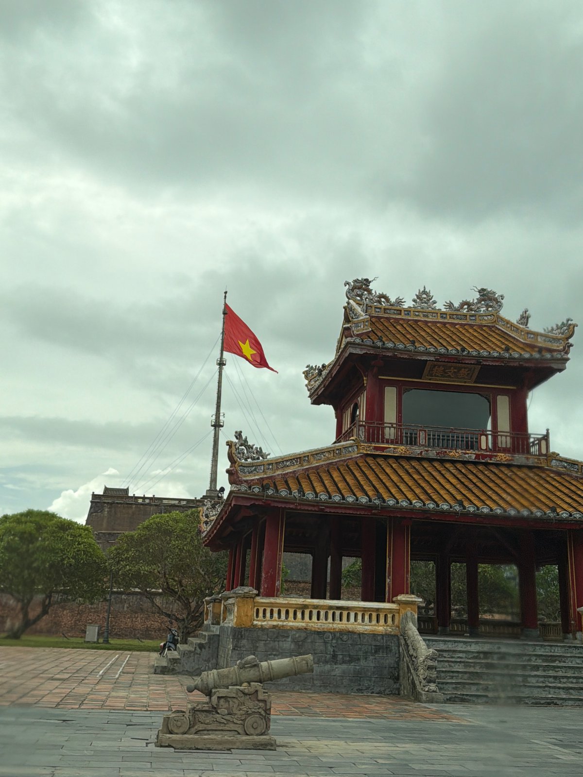 Morning traffic flows past Huế's imperial citadel walls