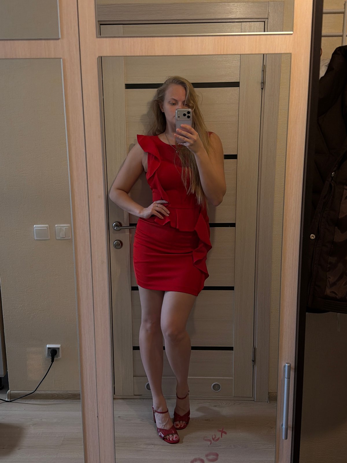 Woman takes mirror selfies in red dress in Izhevsk