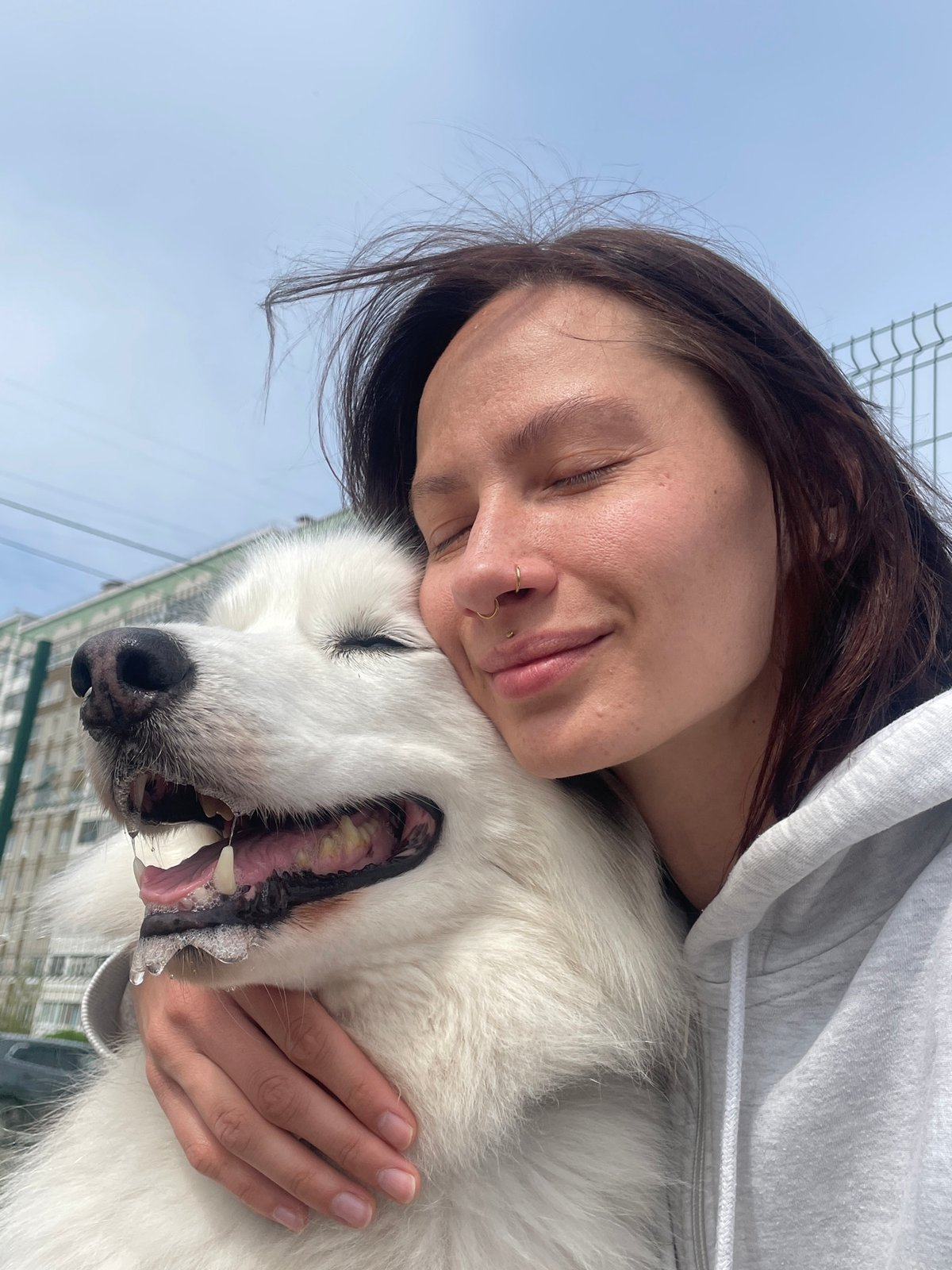 Woman embraces Husky dog in morning moment in Izhevsk