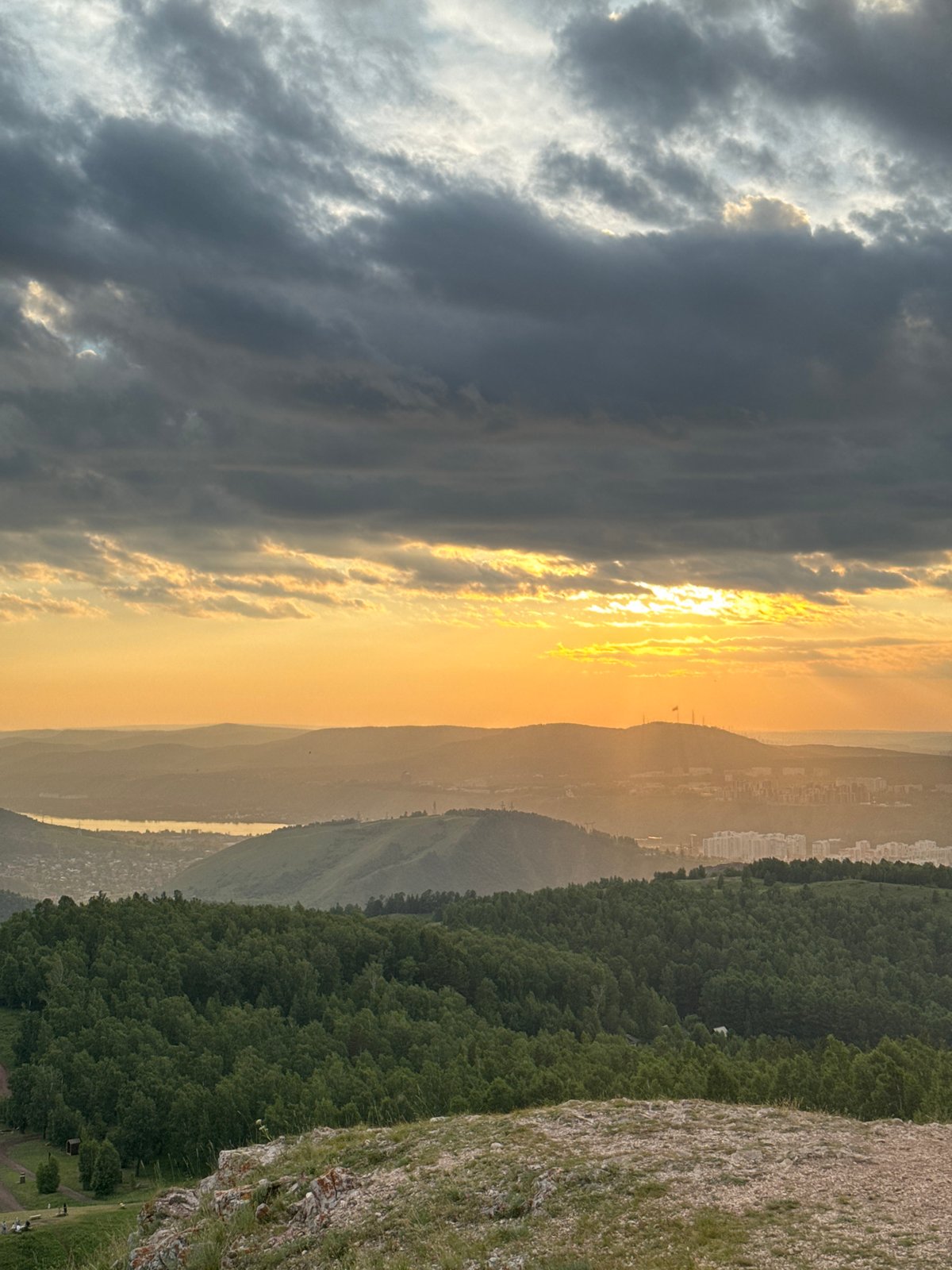 Hilltop sunset view over Krasnoyarsk under dramatic clouds