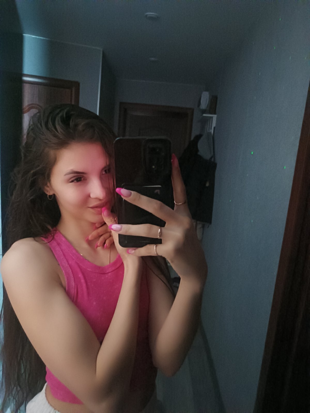 Woman takes selfies at home with starry ceiling projector