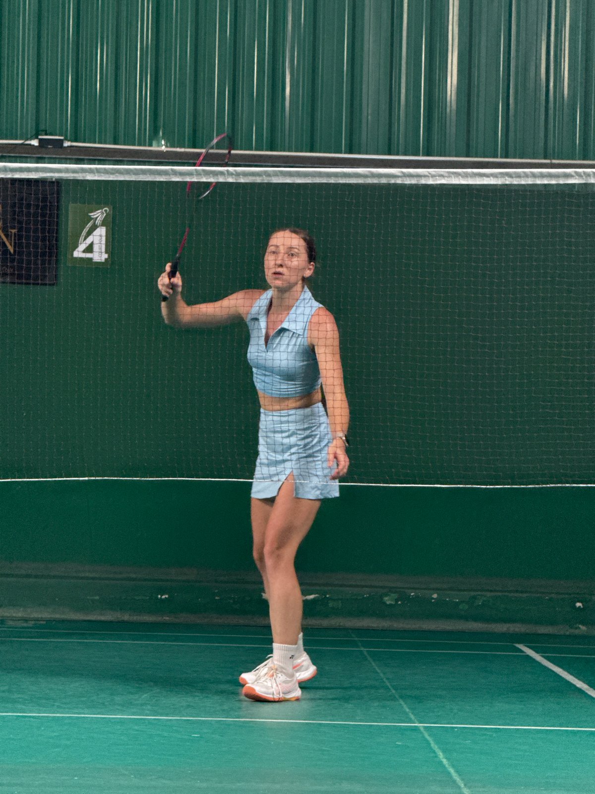 Indoor badminton matches and social activities in Thailand sports facility