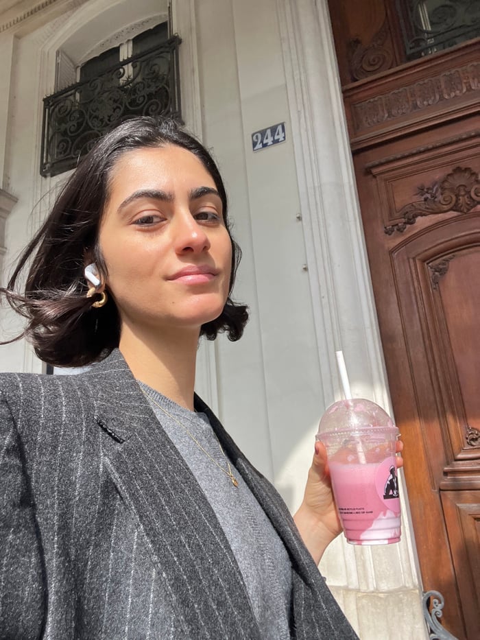 Woman takes selfies near Tuileries Garden in Paris