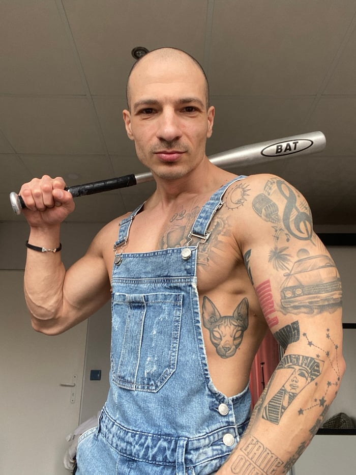 Man poses with baseball bat, flexes in Pleven photoshoot